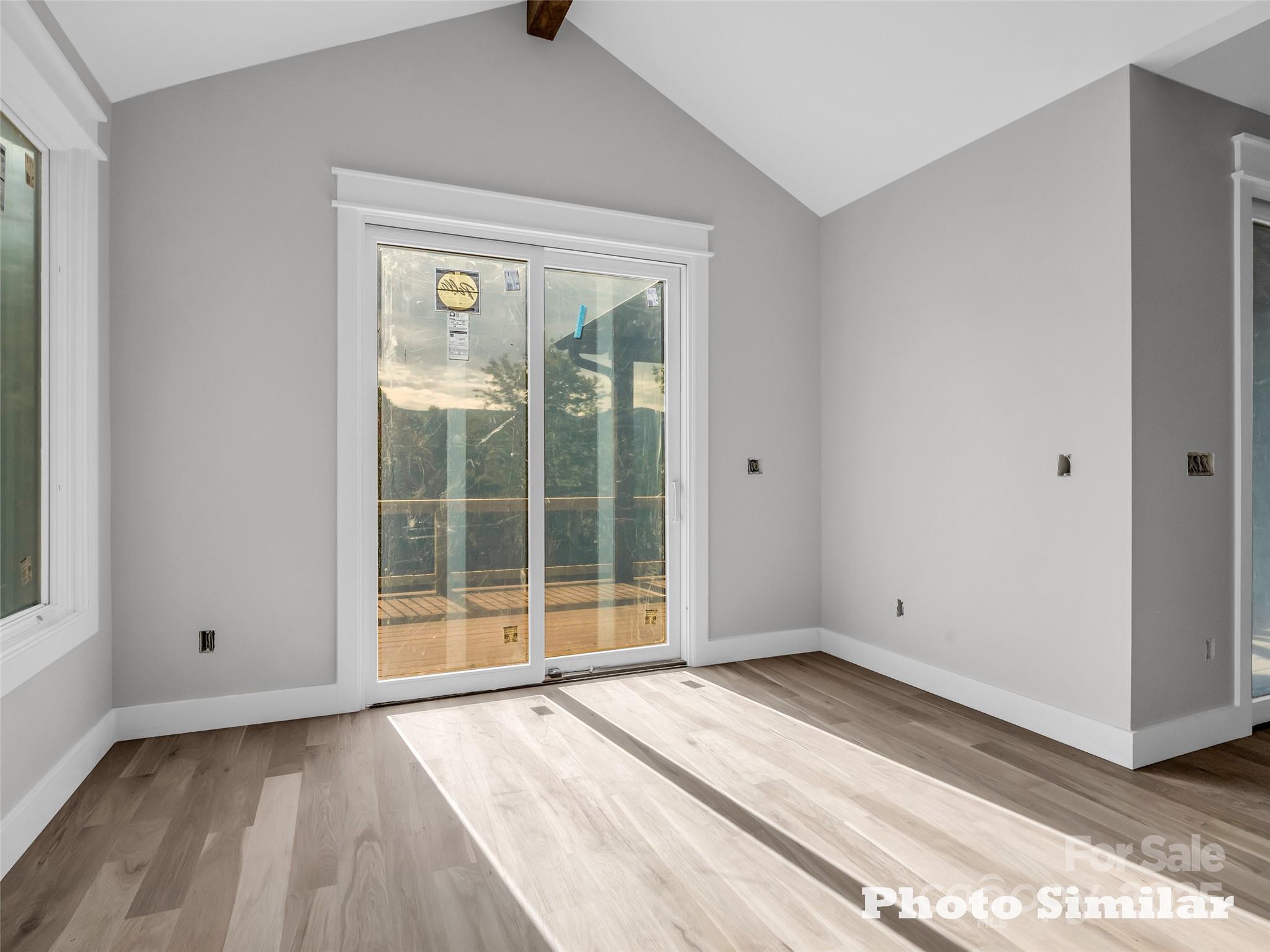 1 Jackson Ridge Ln Mill Spring Mill Spring, NC 28756 - Photo 15 of 36 a view of an empty room with wooden floor and a window