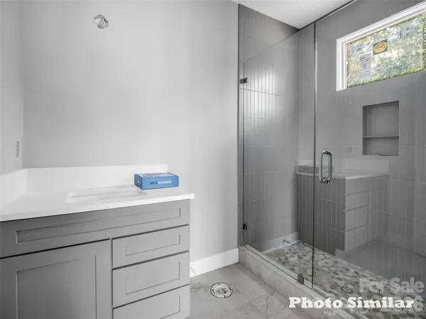 a bathroom with a shower and sink