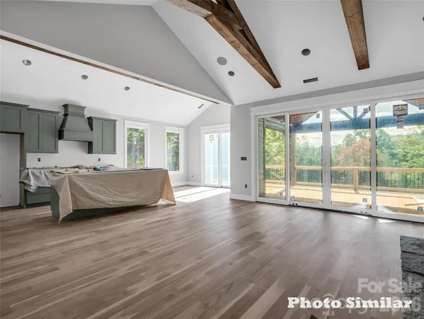 a bedroom with furniture and large window