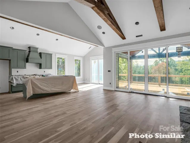 a bedroom with furniture and large window