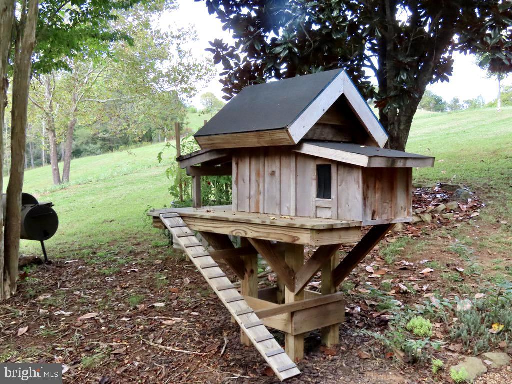 180 5 Forks Road Woodville, VA 22749 - Photo 15 of 44 a view of a house with backyard and sitting area