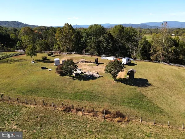 a big yard with trees in the background