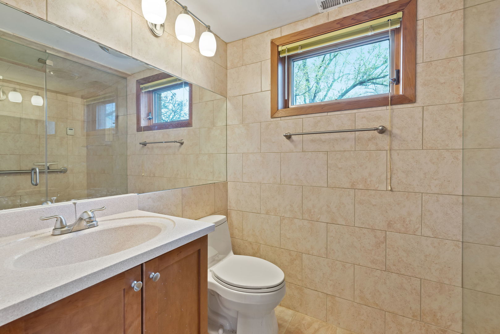 2819 Meyers Road Oak Brook, IL 60523 - Photo 17 of 35 a bathroom with a toilet a sink and mirror
