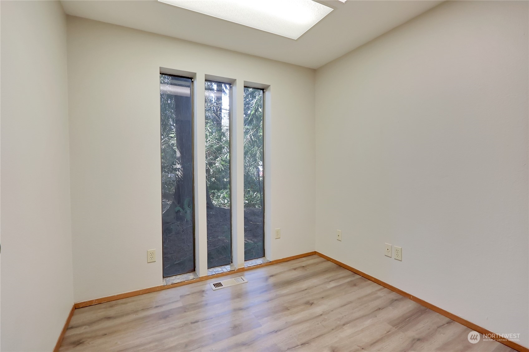 20606 Edwards Road East Lake Tapps, WA 98391 - Photo 20 of 40 a view of an empty room with wooden floor and a window
