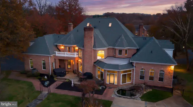 an aerial view of a house with a yard table and chairs