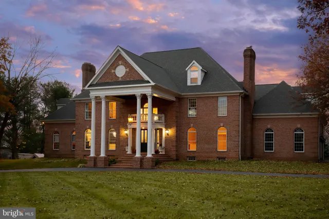 a front view of house with a garden