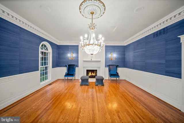 a view of a dining room with furniture wooden floor chandelier and livingroom