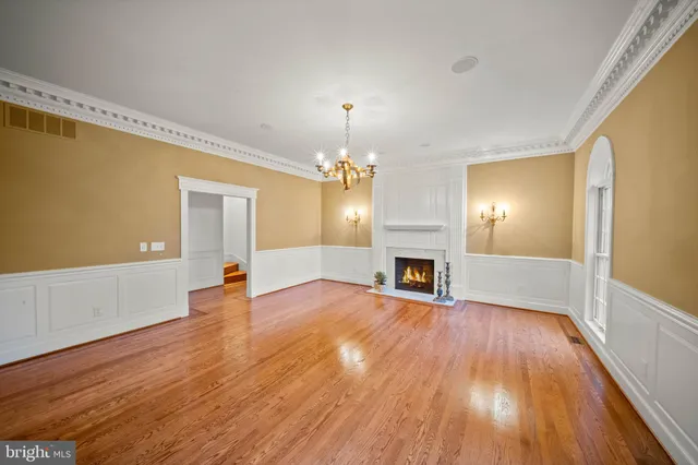 a view of a livingroom with wooden floor fireplace and window