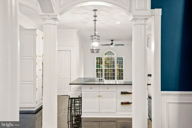 a kitchen with granite countertop a sink and cabinets