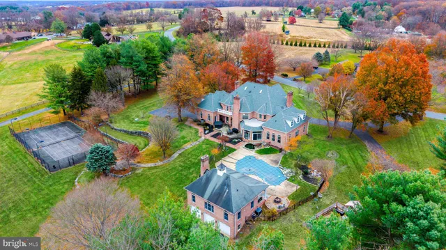 an aerial view of a house with a garden and swimming pool