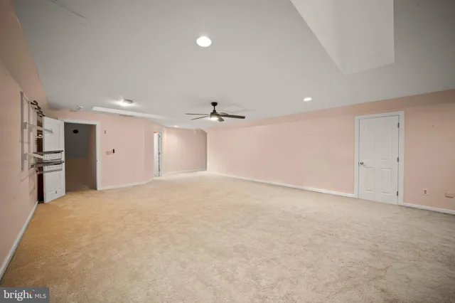 a living room with furniture a fireplace and a chandelier