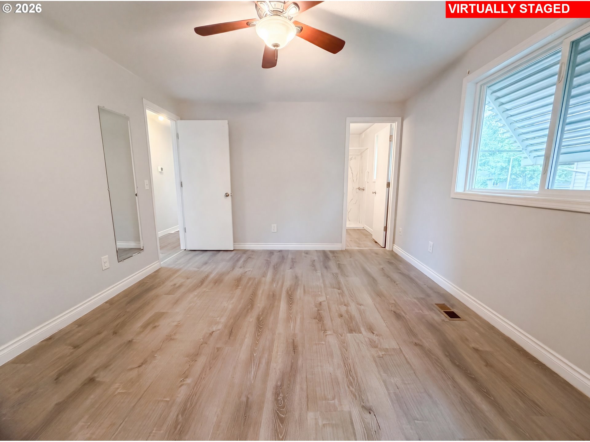 1209 Southwest 25th Street Troutdale, OR 97060 - Photo 4 of 16 an empty room with wooden floor and windows
