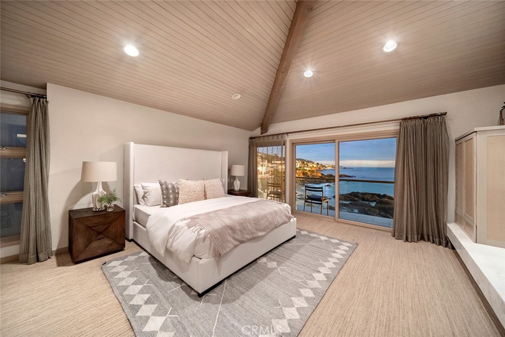 1907 Ocean Way Laguna Beach, CA 92651 - Photo 26 of 74 a spacious bedroom with a bed and a large walk in closet