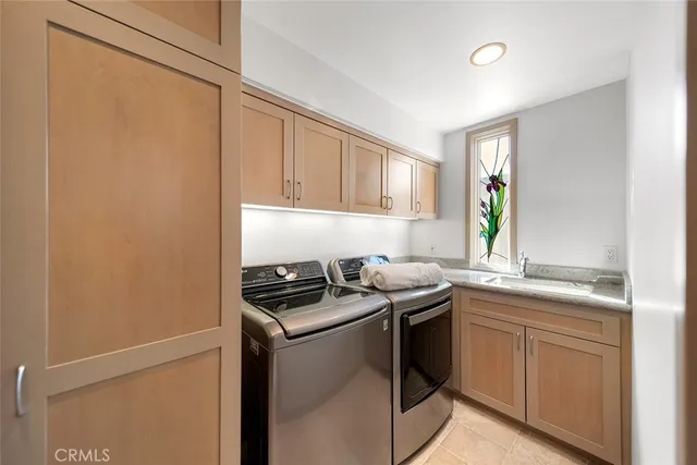 a living room with lots of white furniture and a rug