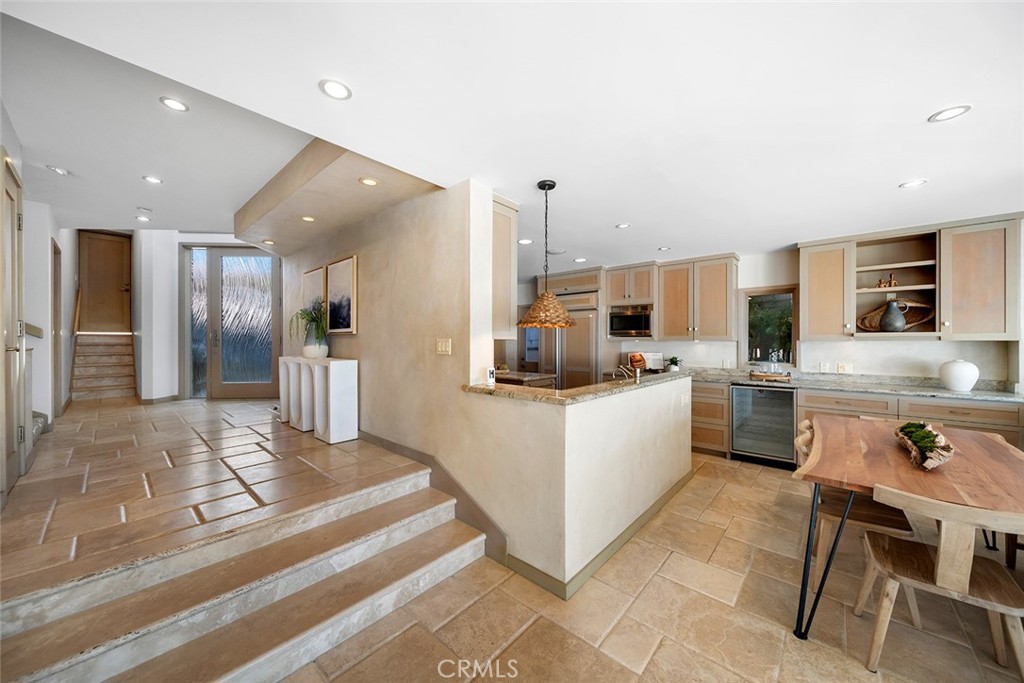 1907 Ocean Way Laguna Beach, CA 92651 - Photo 34 of 74 a kitchen with a refrigerator and white cabinets