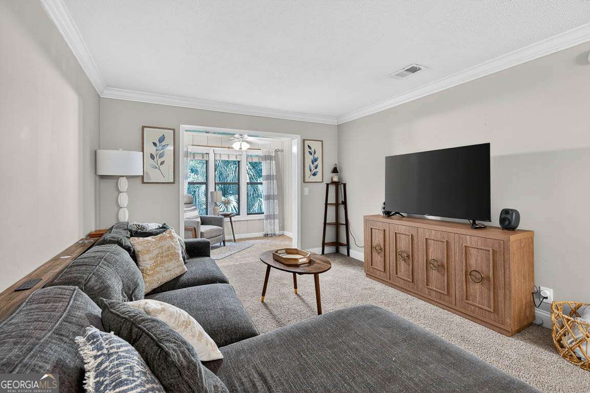 2514 Demere Road, Unit 7 St. Simons, GA 31522 - Photo 10 of 22 a living room with furniture and a flat screen tv