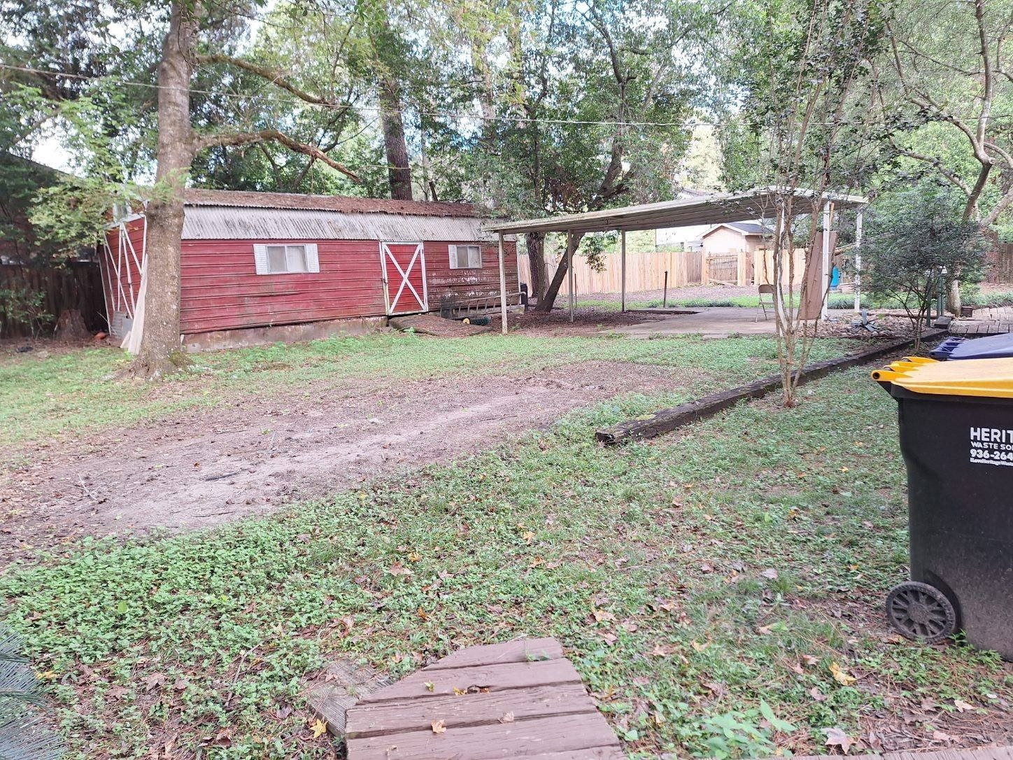 12505 Rollingwood Loop Conroe, TX 77303 - Photo 11 of 24 a view of a house with backyard and a garden