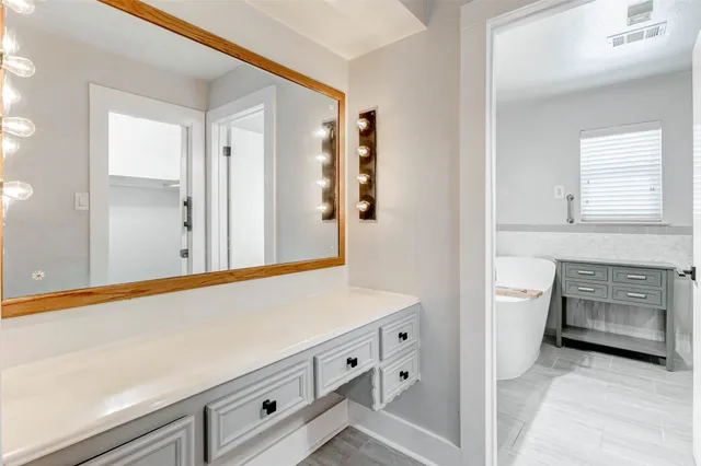 a bathroom with a double vanity sink and a mirror