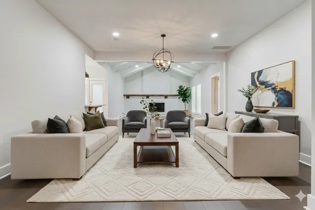 a dining room with wooden floor a chandelier a wooden table and chairs