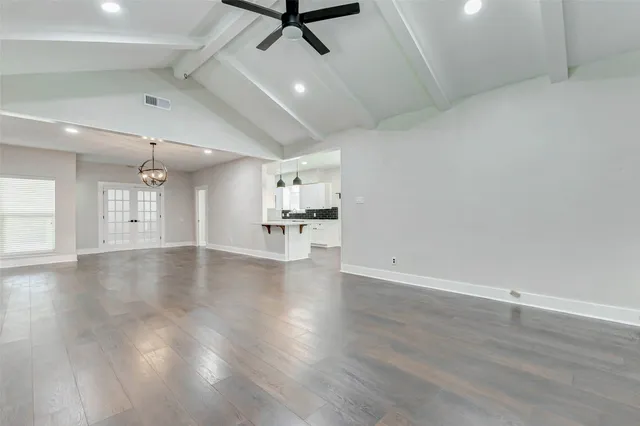 a large kitchen with stainless steel appliances and white cabinets