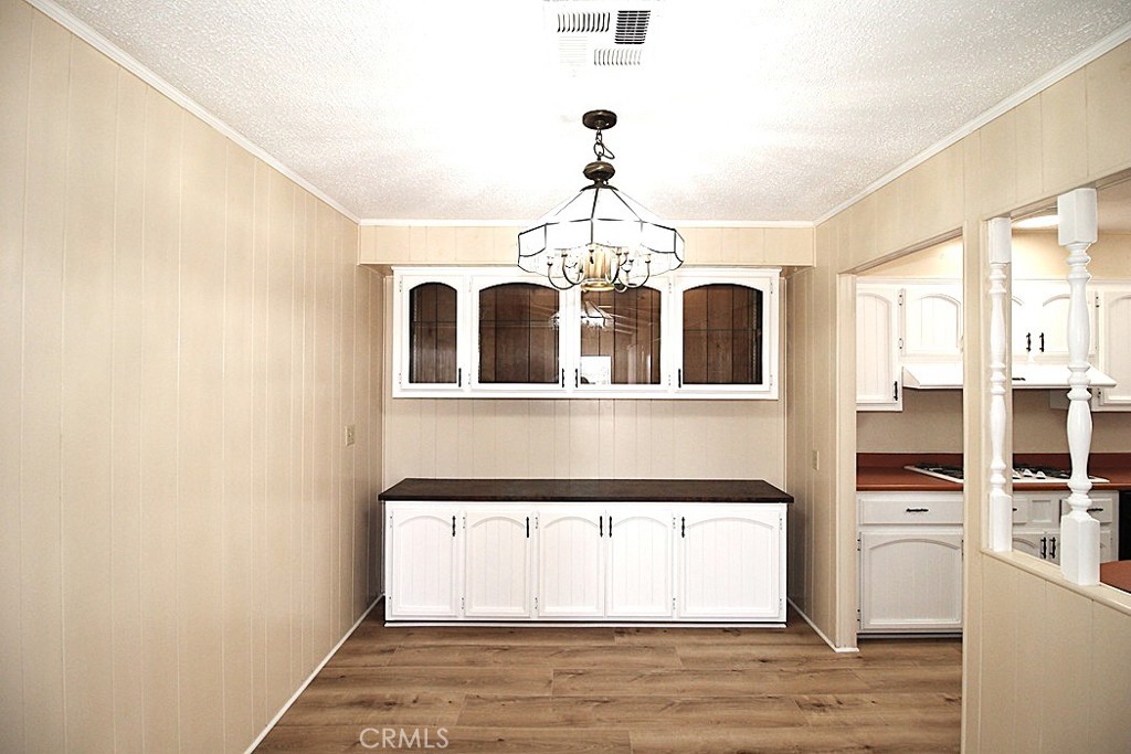 3750 Main Street Barstow, CA 92311 - Photo 16 of 39 a view of a room with wooden floor and chandelier
