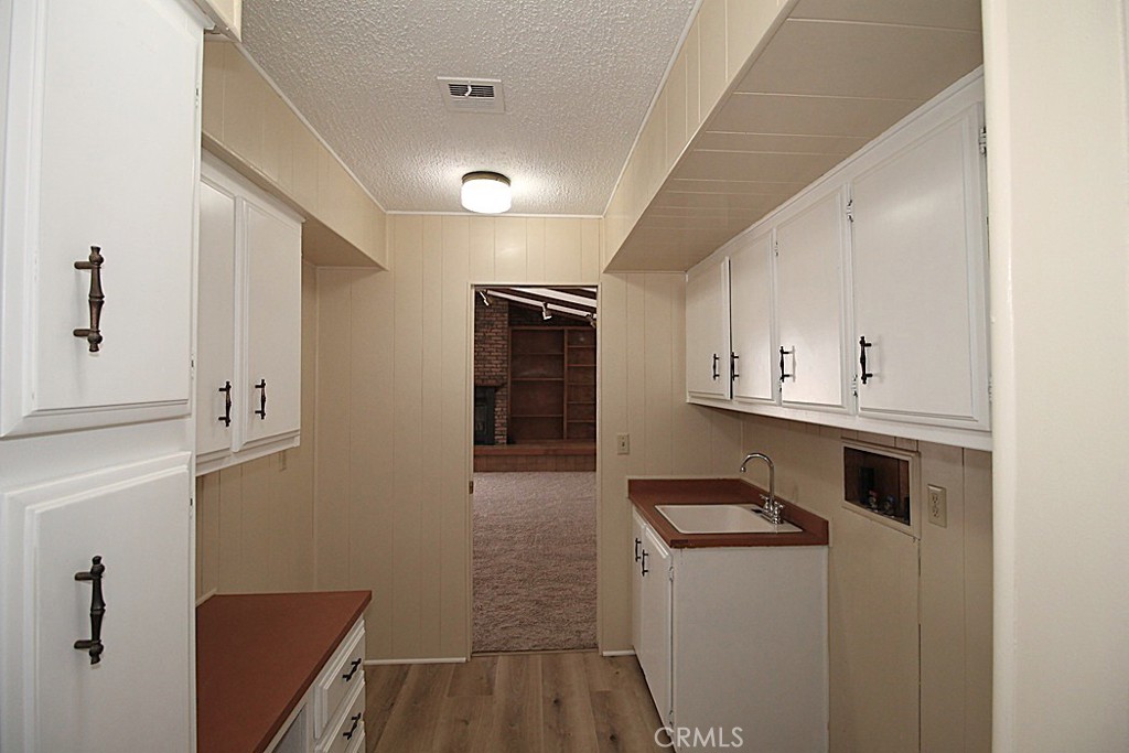 3750 Main Street Barstow, CA 92311 - Photo 28 of 39 a kitchen with granite countertop white cabinets and white appliances