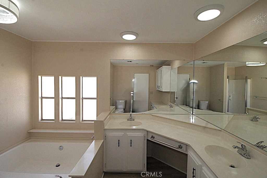 3750 Main Street Barstow, CA 92311 - Photo 39 of 39 a bathroom with a granite countertop sink mirror and double