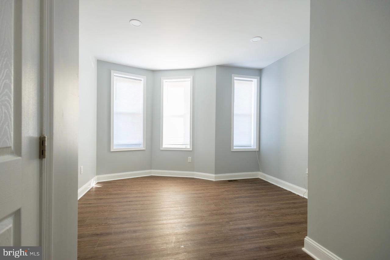 820 North Monroe Street Baltimore, MD 21217 - Photo 12 of 23 a view of empty room with wooden floor and fan