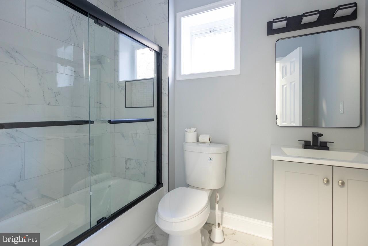 820 North Monroe Street Baltimore, MD 21217 - Photo 14 of 23 a white toilet sitting next to a bathroom sink