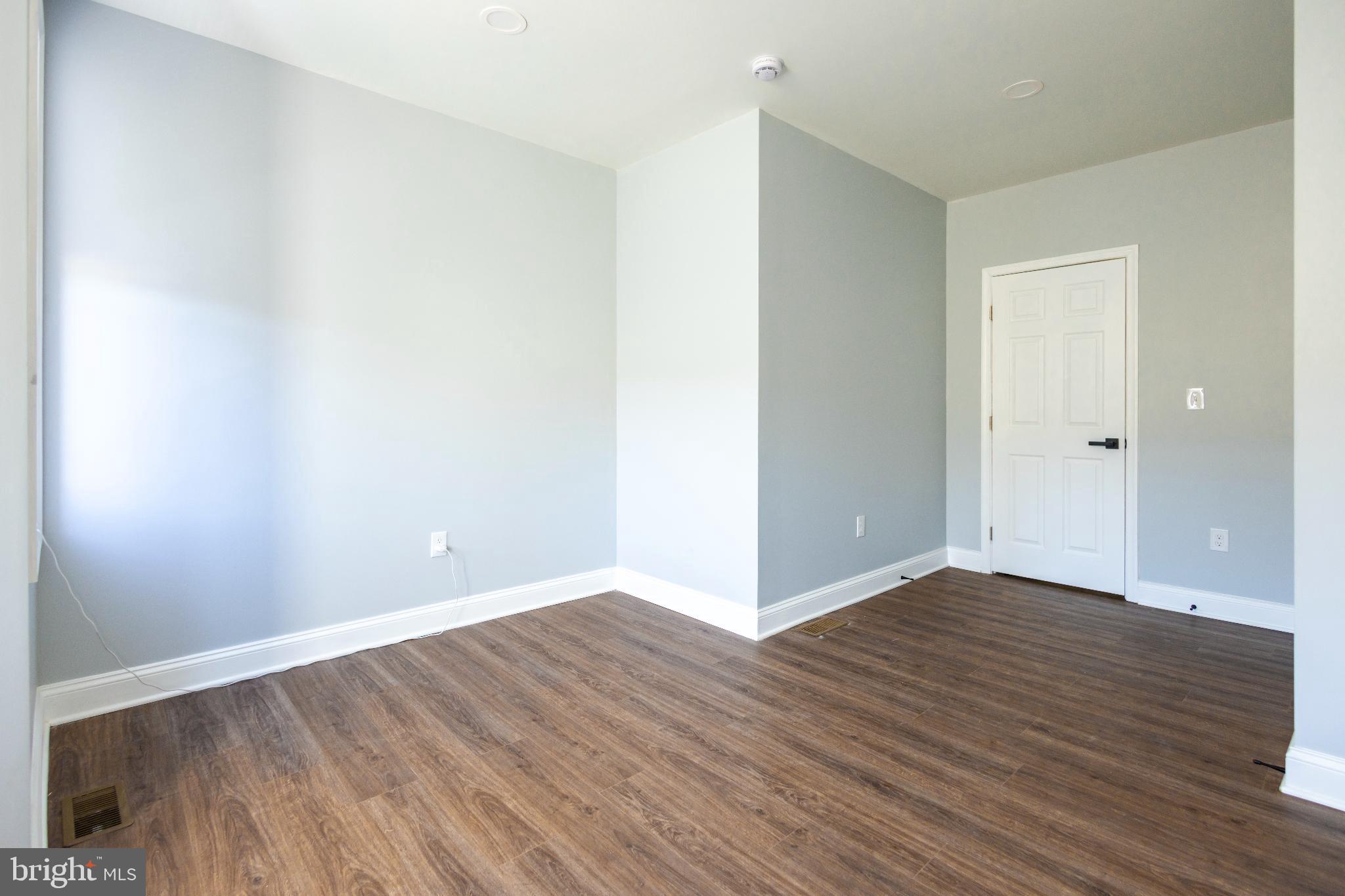 820 North Monroe Street Baltimore, MD 21217 - Photo 15 of 23 a view of an empty room with wooden floor