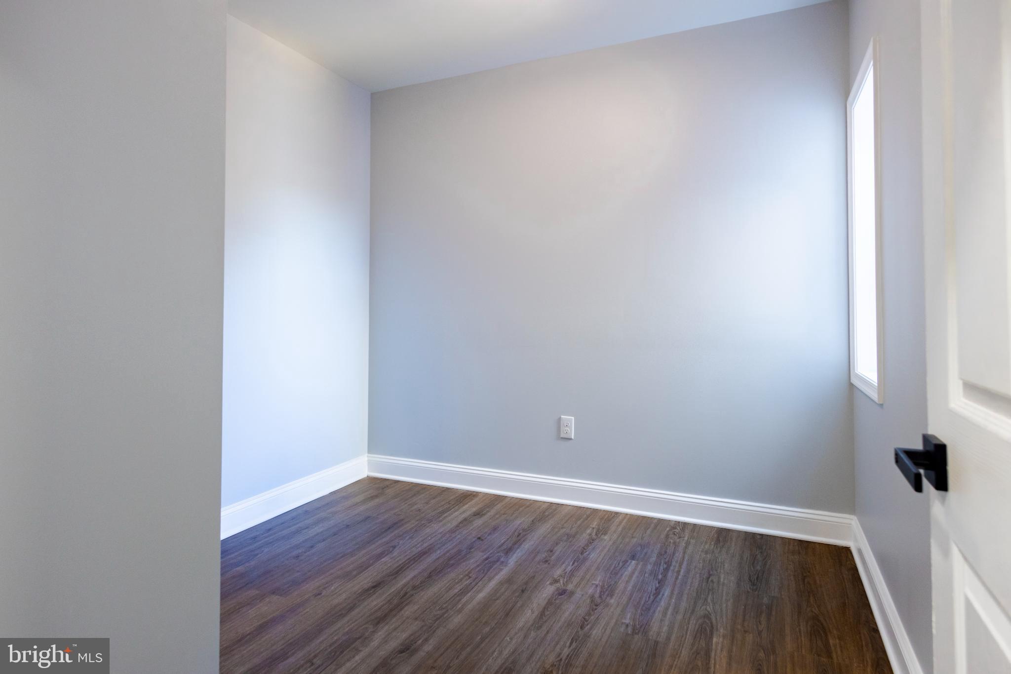 820 North Monroe Street Baltimore, MD 21217 - Photo 18 of 23 a view of an empty room with wooden floor and a window
