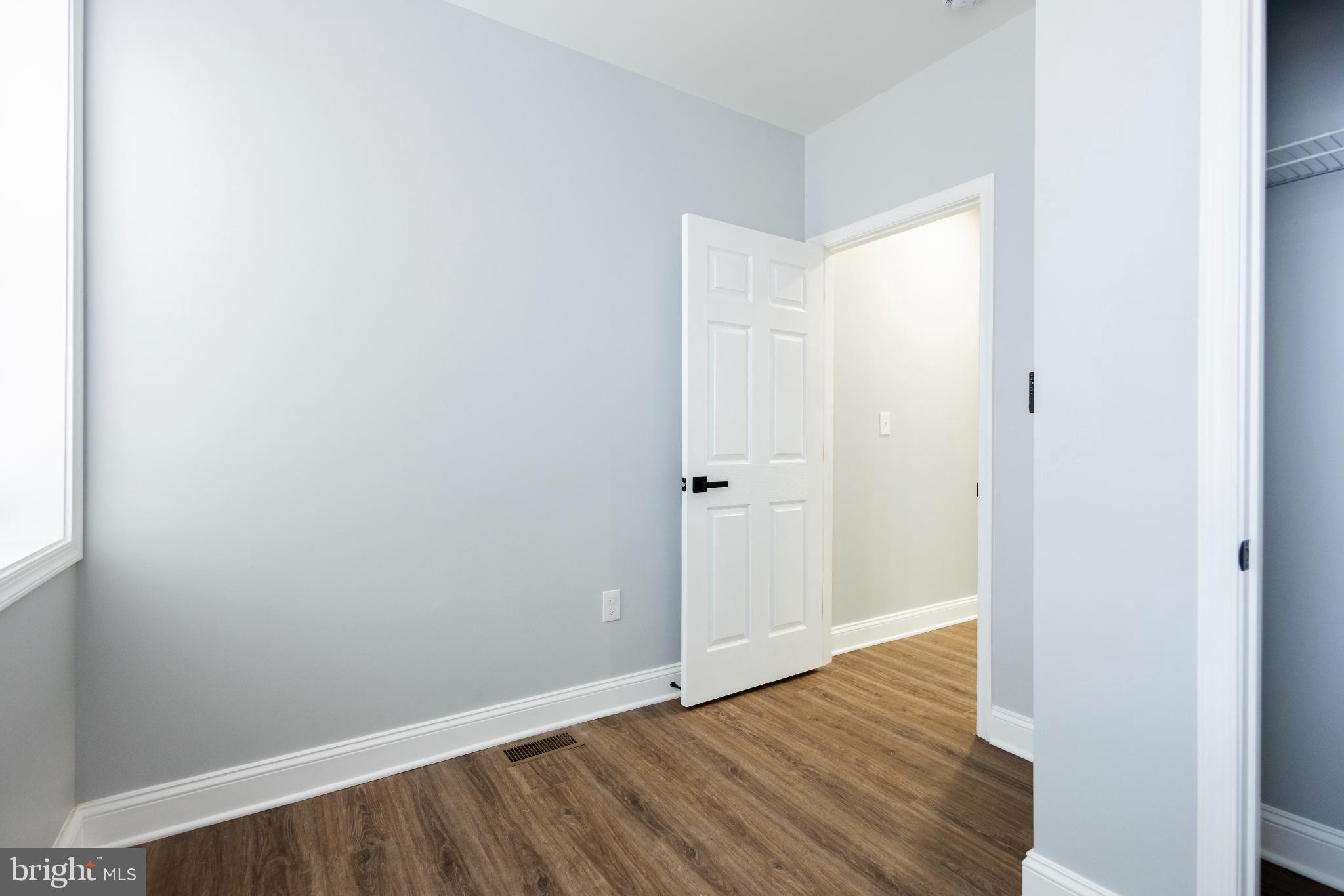 820 North Monroe Street Baltimore, MD 21217 - Photo 19 of 23 a view of an empty room with wooden floor