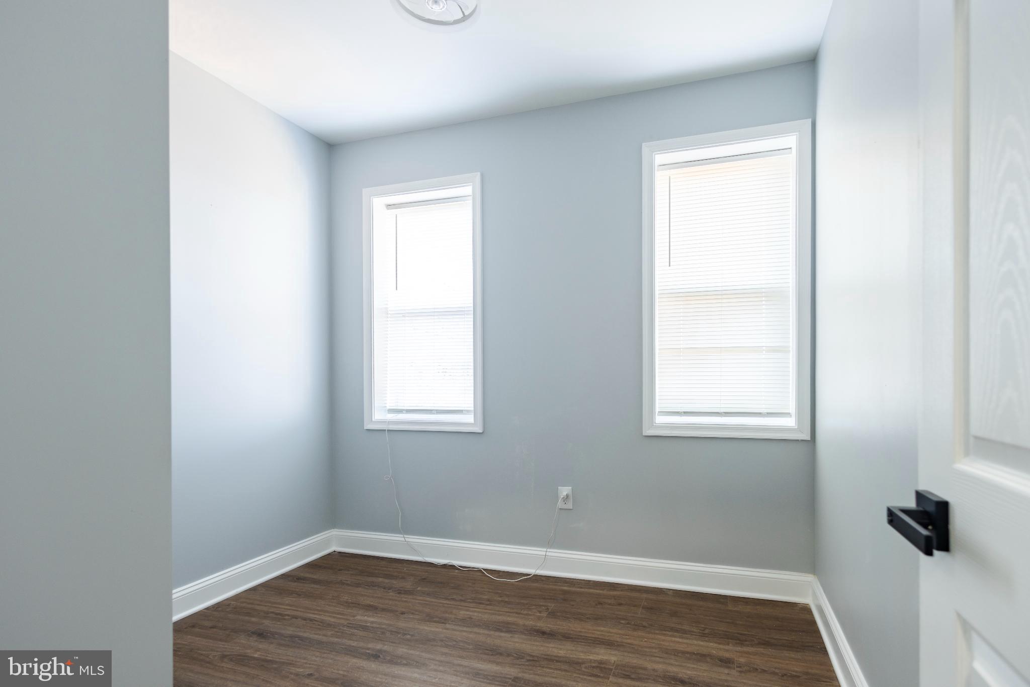 820 North Monroe Street Baltimore, MD 21217 - Photo 20 of 23 an empty room with wooden floor and windows