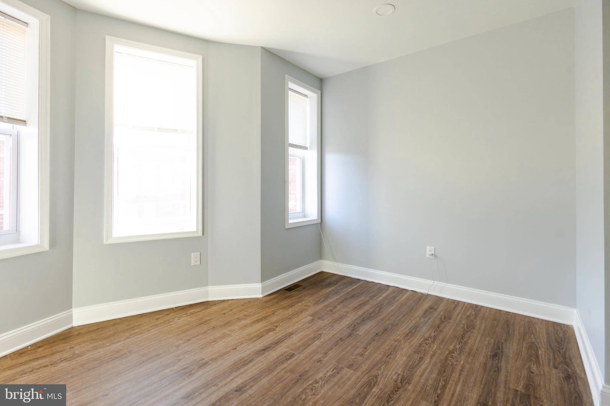 820 North Monroe Street Baltimore, MD 21217 - Photo 22 of 23 an empty room with wooden floor and windows