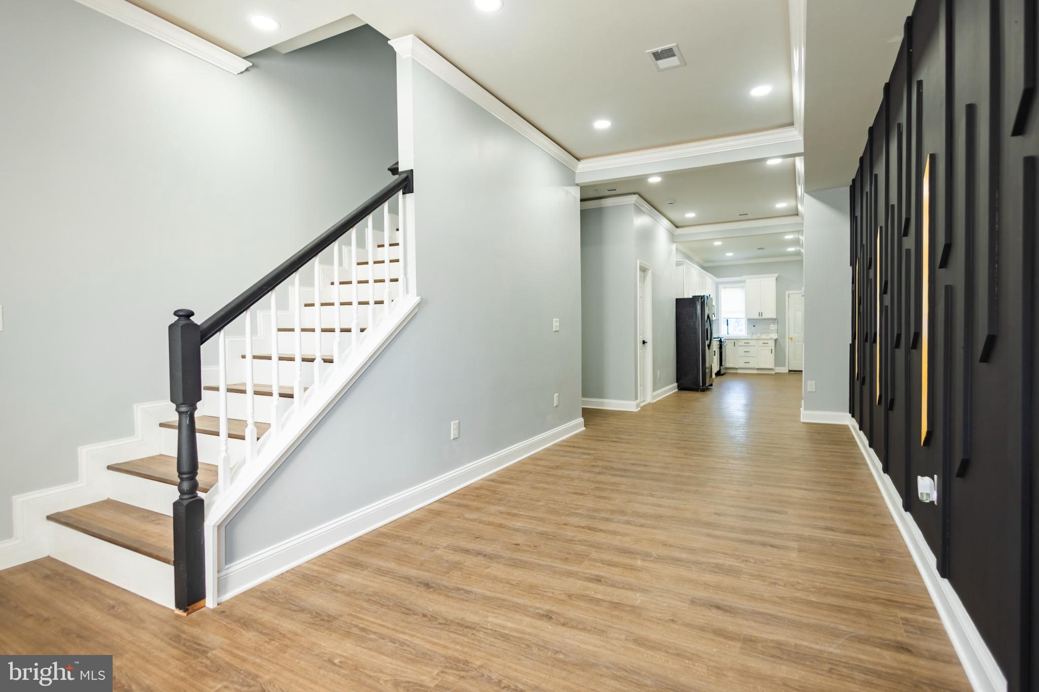820 North Monroe Street Baltimore, MD 21217 - Photo 4 of 23 a view of a hallway with wooden floor and staircase