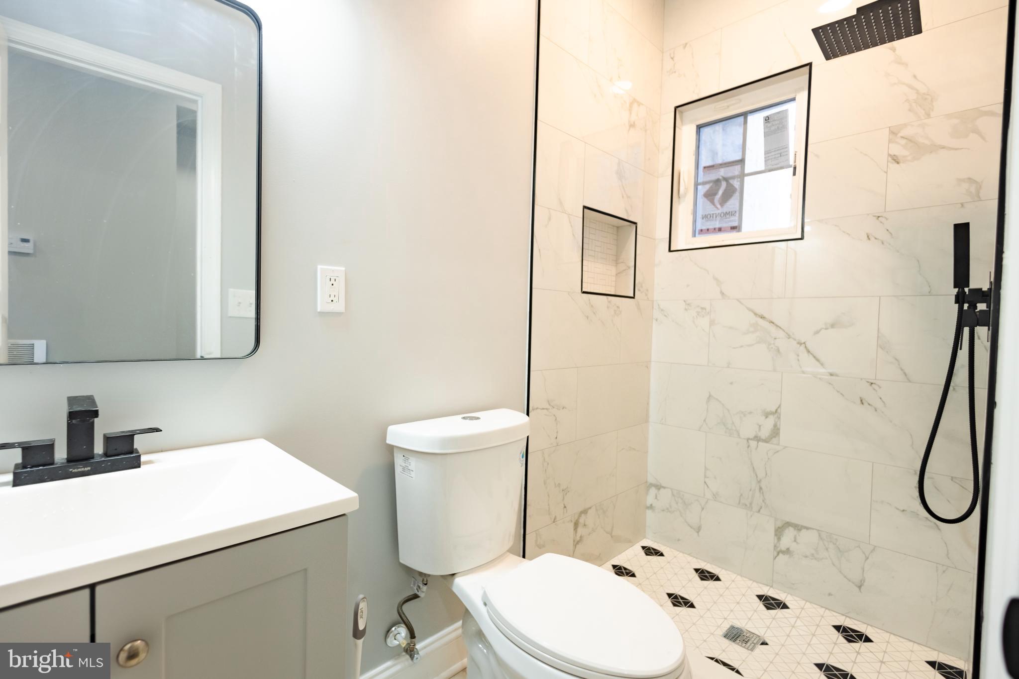 820 North Monroe Street Baltimore, MD 21217 - Photo 6 of 23 a bathroom with a sink a toilet and shower