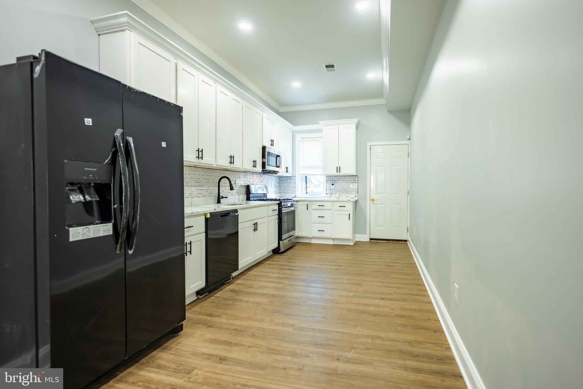 820 North Monroe Street Baltimore, MD 21217 - Photo 7 of 23 a kitchen with stainless steel appliances a refrigerator sink and cabinets