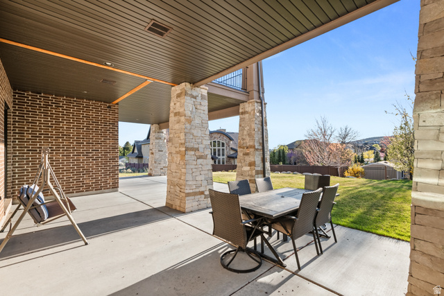 1205 North Elk Rdg Lane, Unit 202 Alpine, UT 84004 - Photo 70 of 88 Expansive covered patio with concrete flooring and stone pillars