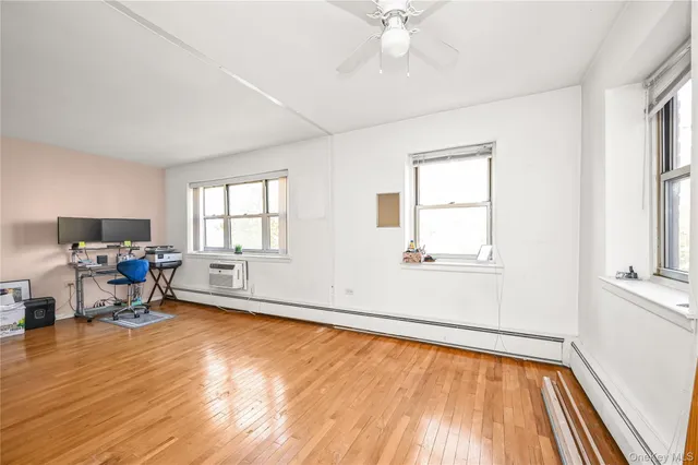 a view of a livingroom with a window and wooden floor