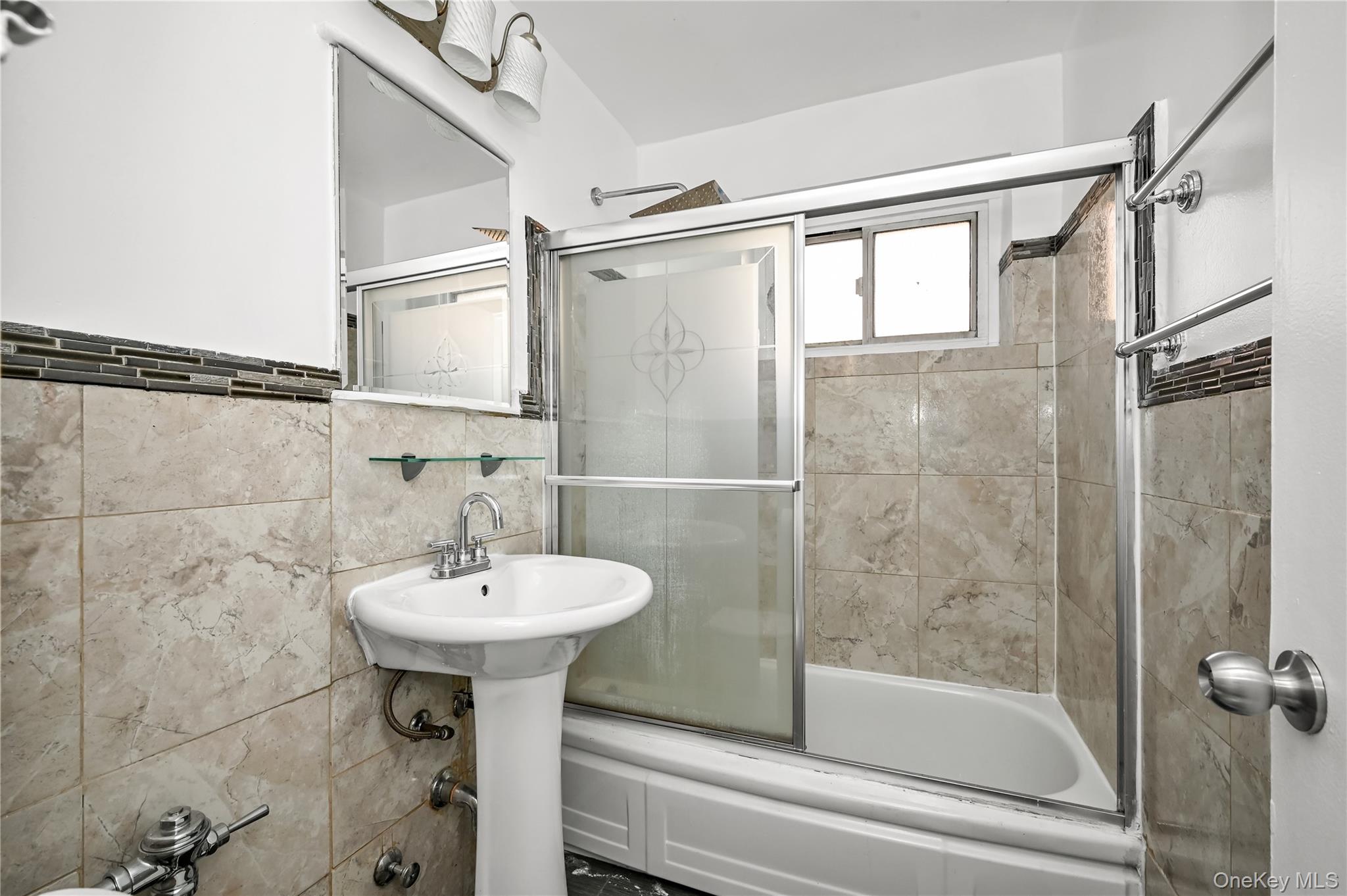 99-10 60th Avenue, Unit 3B Queens, NY 11368 - Photo 16 of 25 a bathroom with a sink toilet and shower