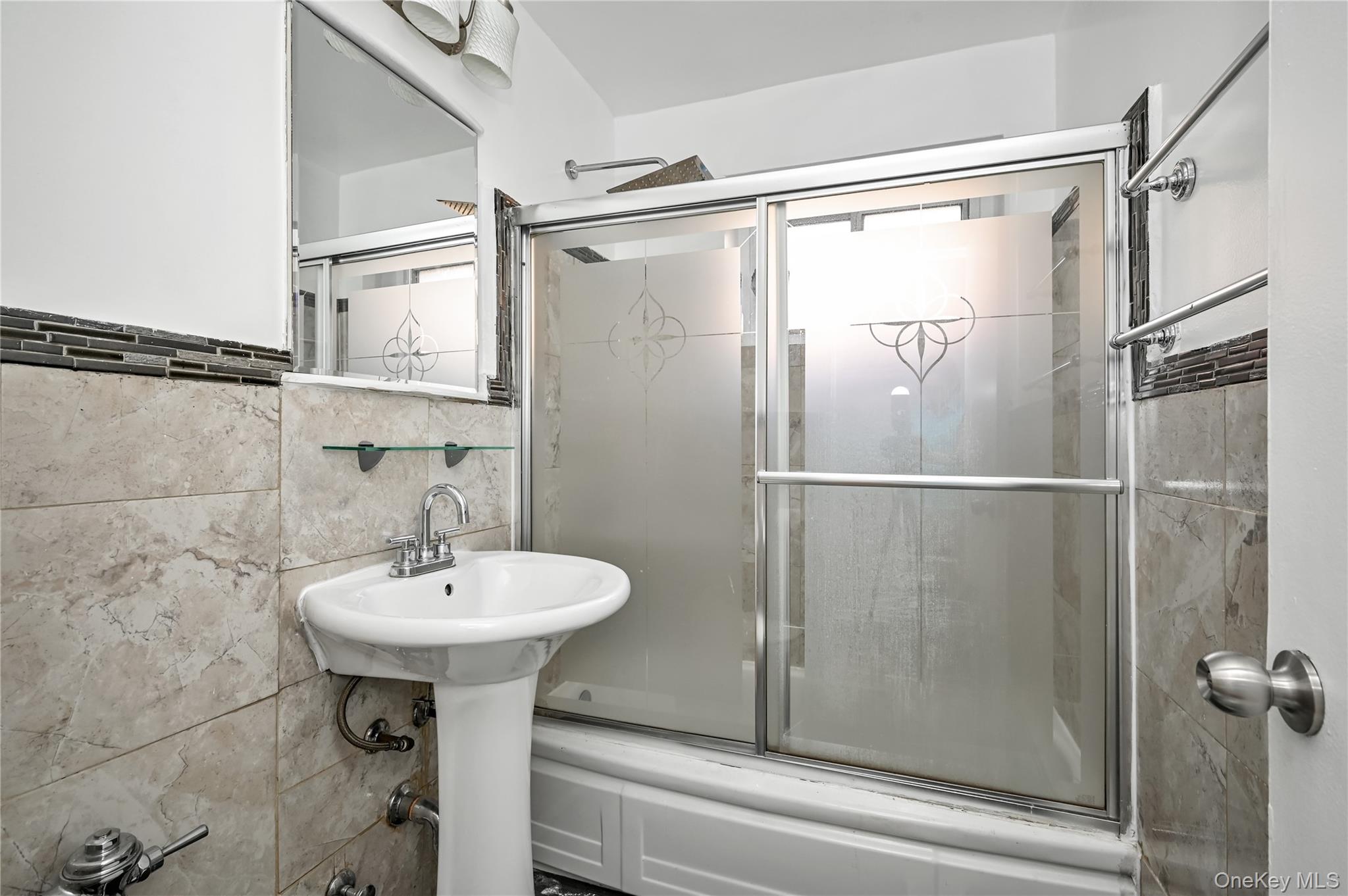 99-10 60th Avenue, Unit 3B Queens, NY 11368 - Photo 17 of 25 a bathroom with a sink and mirror