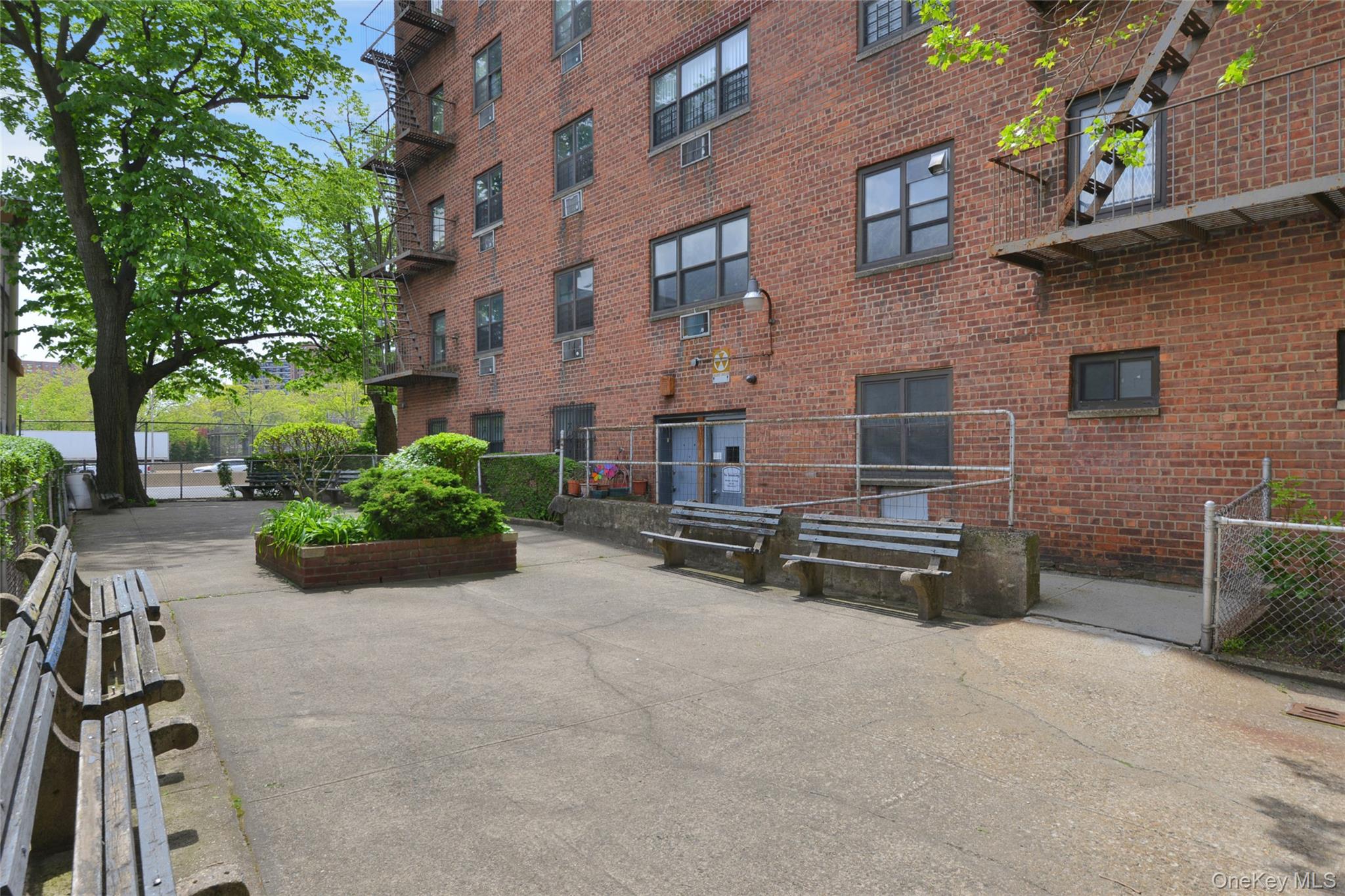 99-10 60th Avenue, Unit 3B Queens, NY 11368 - Photo 23 of 25 a view of a patio with chairs and potted plants
