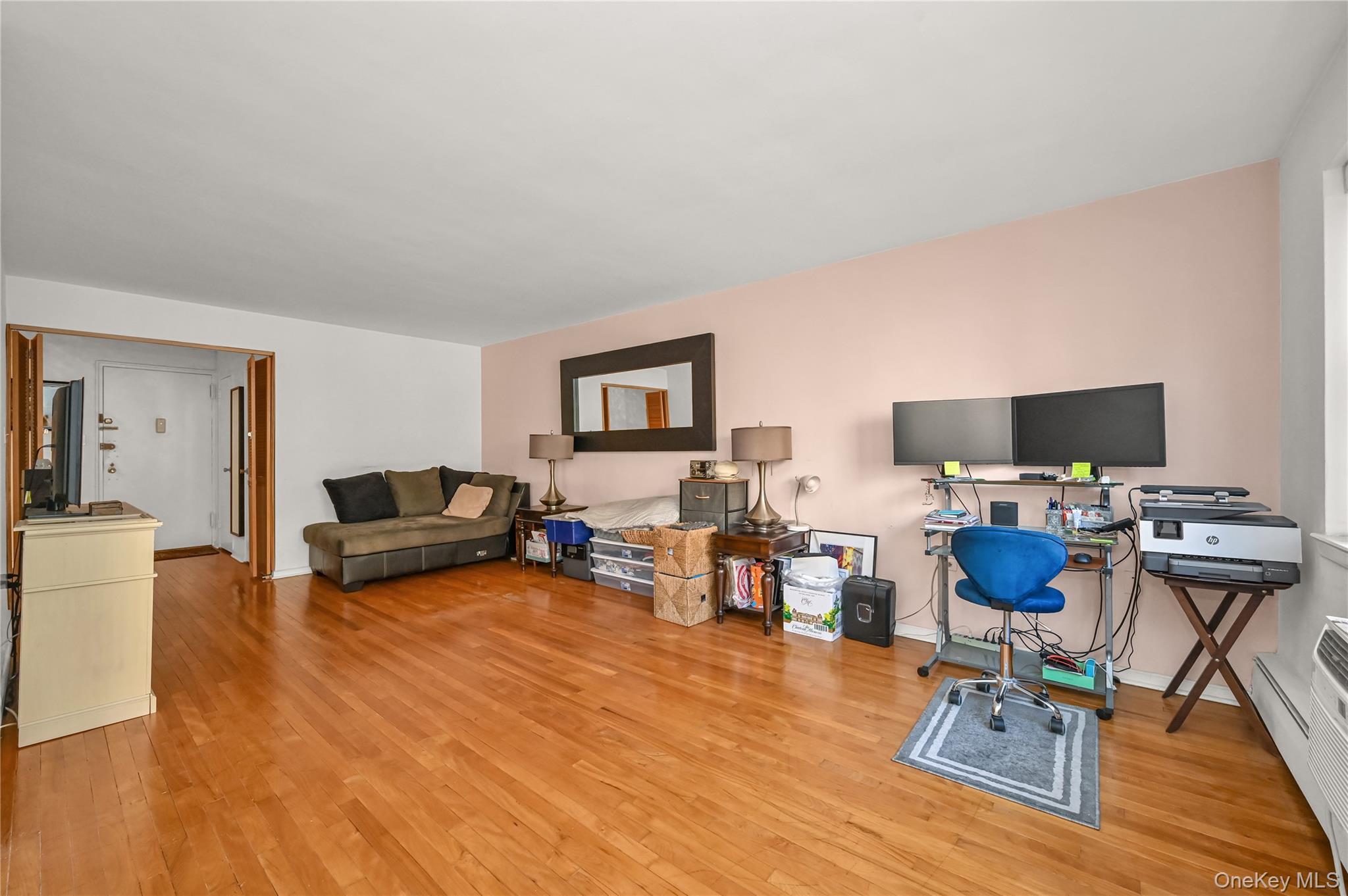 99-10 60th Avenue, Unit 3B Queens, NY 11368 - Photo 6 of 25 a living room with furniture and a flat screen tv