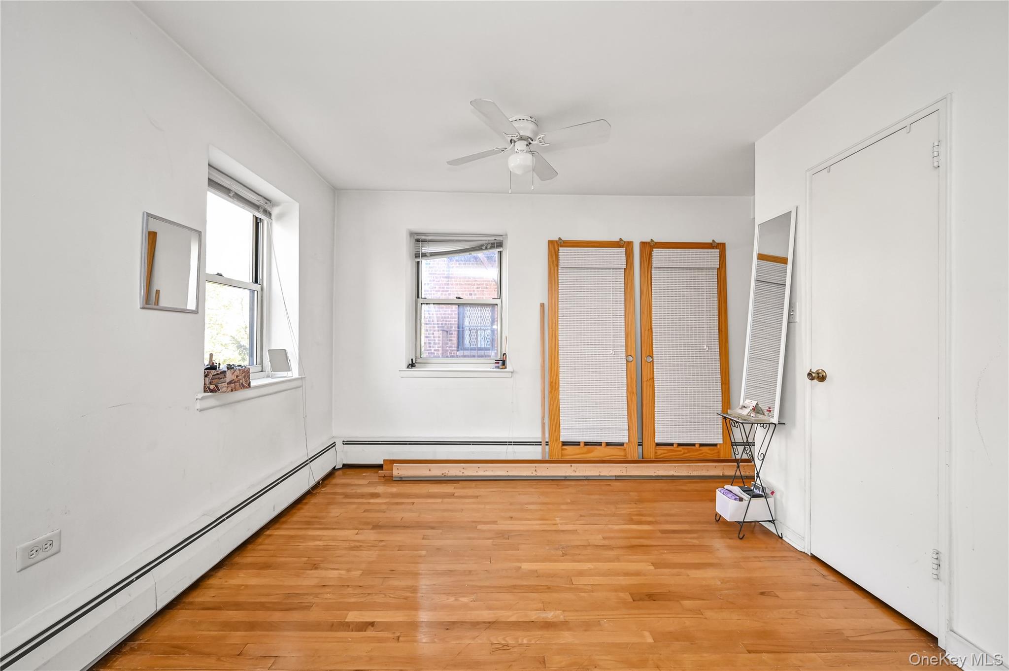 99-10 60th Avenue, Unit 3B Queens, NY 11368 - Photo 9 of 25 an empty room with windows