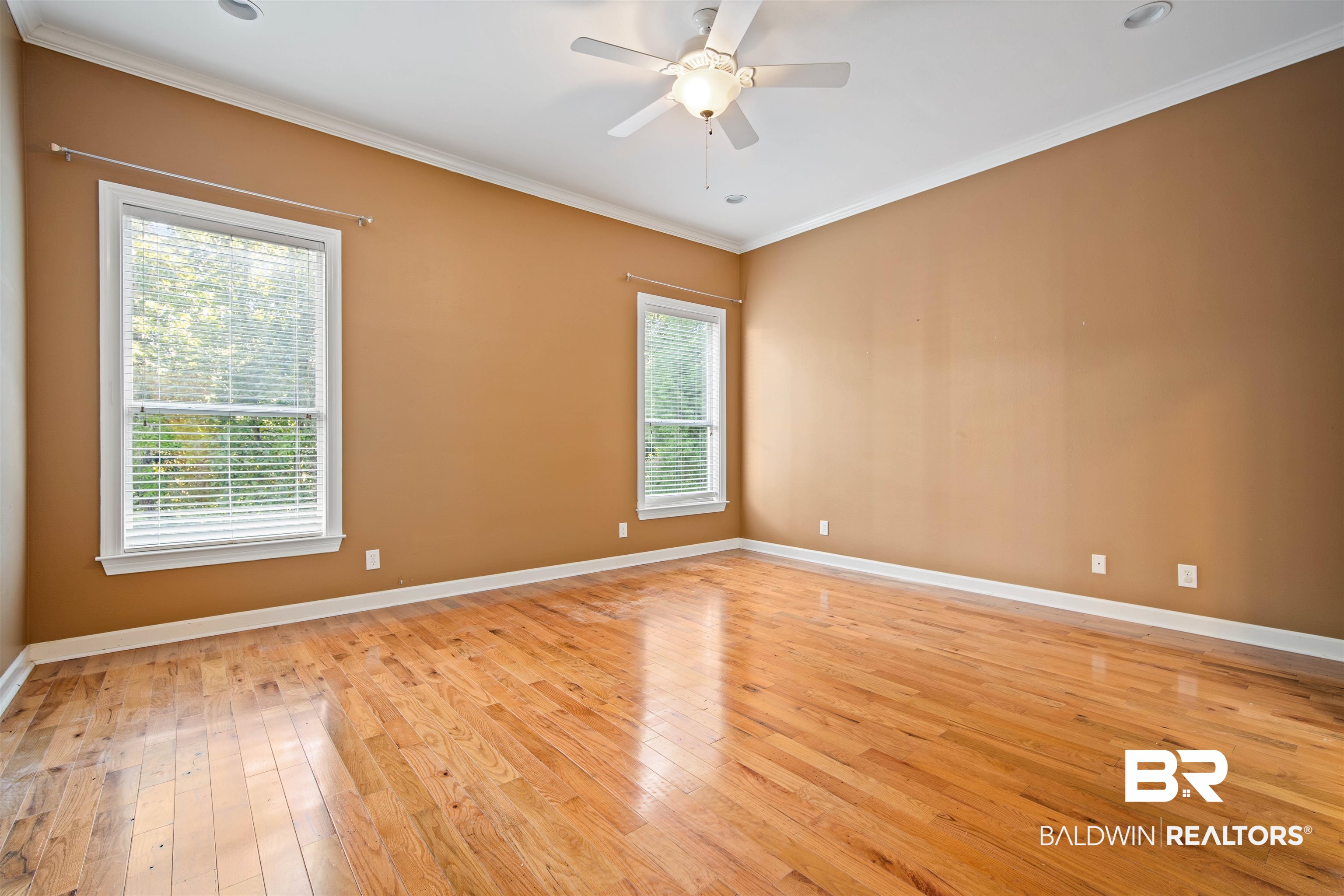 204 General Canby Loop Daphne, AL 36527 - Photo 17 of 36 Empty room featuring ornamental molding, light wood-type flooring, and ceiling fan