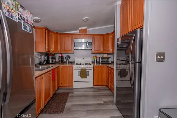 a kitchen with stainless steel appliances granite countertop a refrigerator sink and cabinets