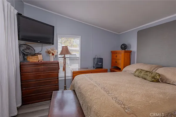 a bedroom with a bed and flat screen tv