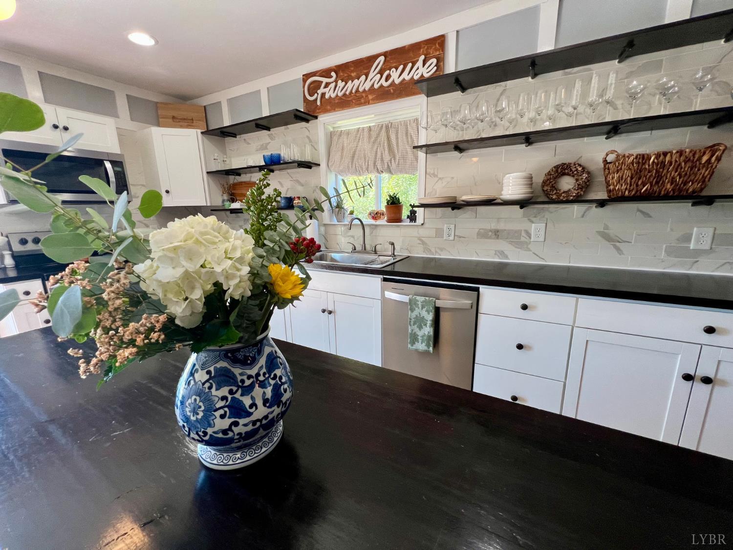 120 North Main Street Amherst, VA 24521 - Photo 22 of 62 a kitchen with a sink a stove and cabinets