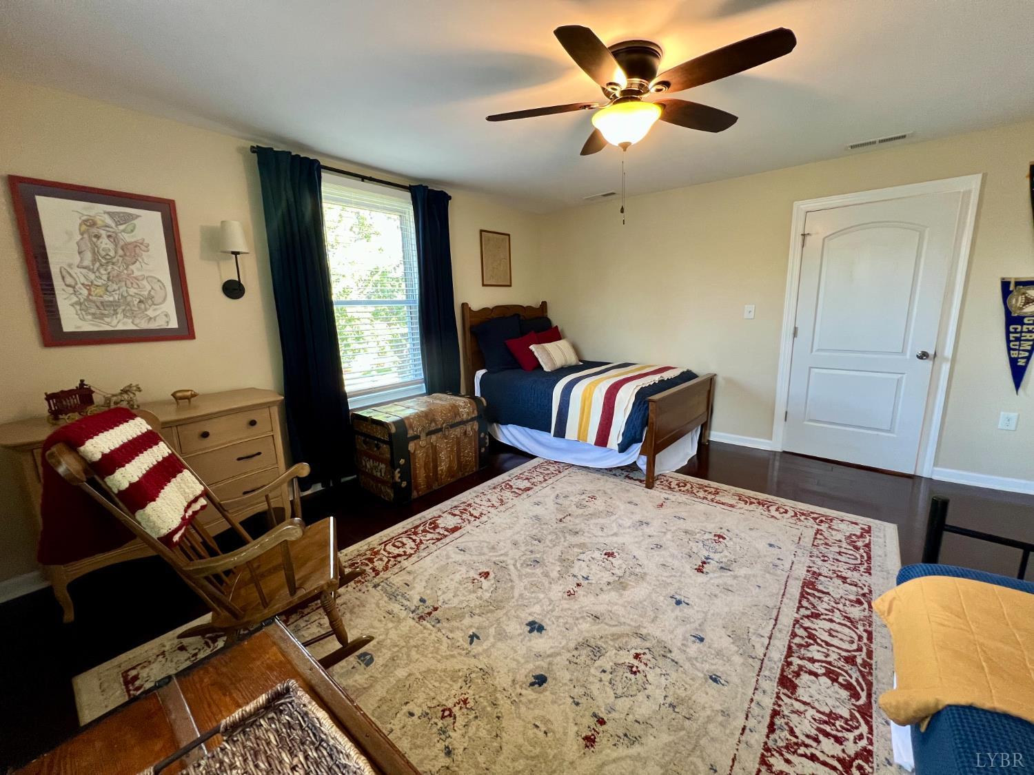 120 North Main Street Amherst, VA 24521 - Photo 39 of 62 a bedroom with a bed and wooden floor