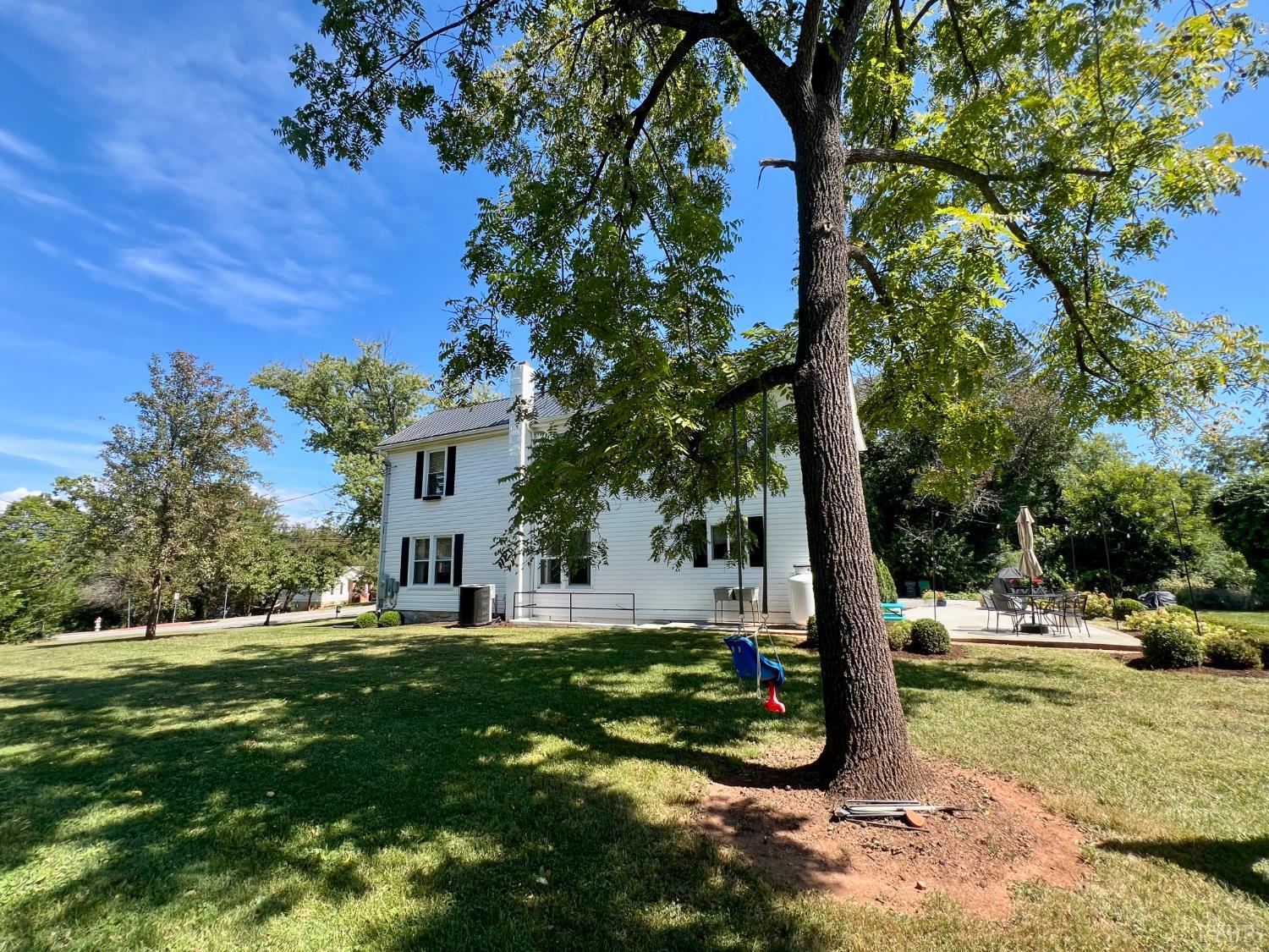 120 North Main Street Amherst, VA 24521 - Photo 47 of 62 a view of a white house with a big yard and large tree